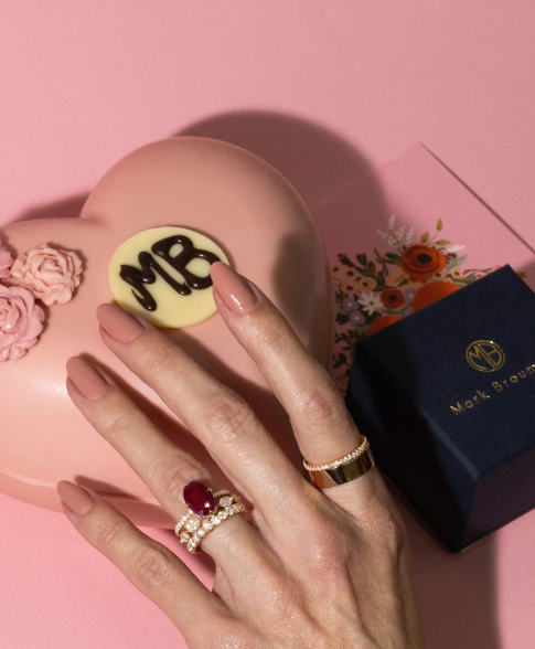 A woman wears the engagement ring and wedding band she bought together.