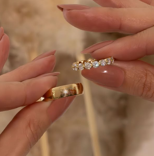 A woman is holding the most common Women’s and Men’s Wedding Ring.