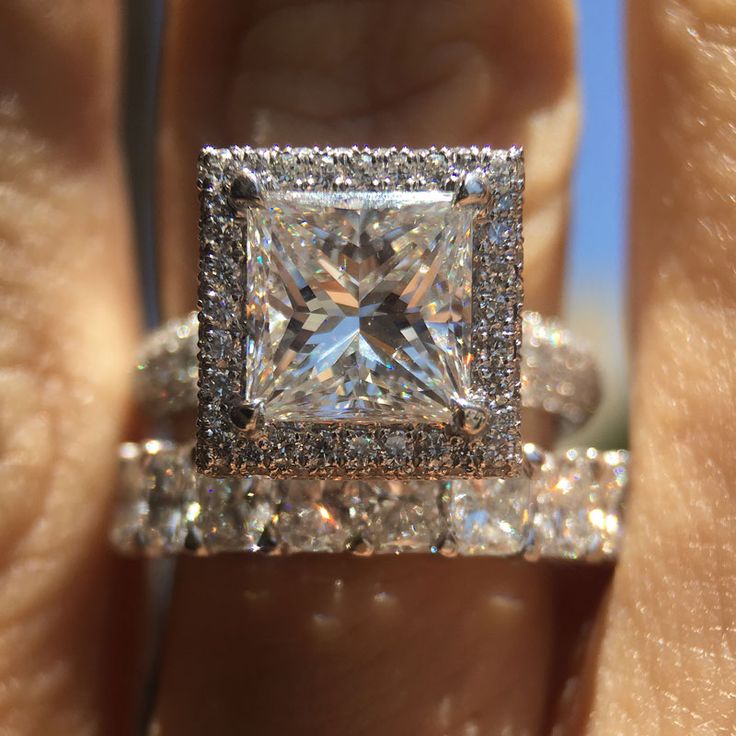 A woman holds a Princess Cut Diamond Engagement Ring. The Princess Cut is one of the most valuable Diamond Cuts.