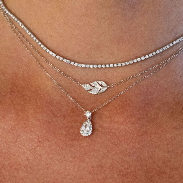 A woman wears multiple Diamond Necklaces, symbolizing love and strength.